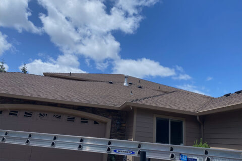 Professional roof and gutter cleaning on large residential home in Keizer, Oregon – safe high-access work with ladder and equipment by Dou-Glass team